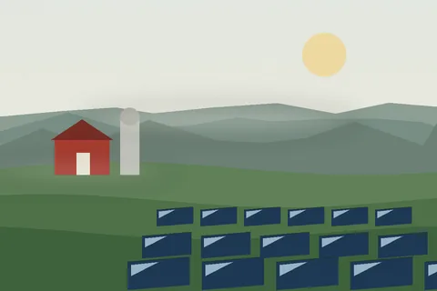 Solar panels on a pasture before a red barn and silo under a hazy morning sky